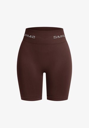 Brązowe szorty wykonane z miękkiego, elastycznego materiału. Posiadają szeroką gumkę w talii z napisem "SMIL" w kolorze białym. Gładka faktura i długość do połowy uda.
