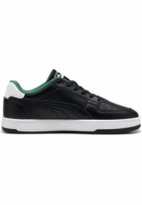 Black leather sneakers with green accents, white midsole, and minimal perforations. Features a black lace closure and logo detailing.