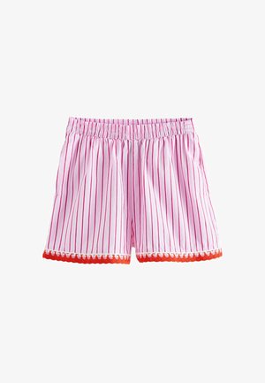 Pantalones cortos con rayas verticales en rosa y blanco, cintura elástica y ribete ondulado naranja en el dobladillo, sobre un fondo blanco.