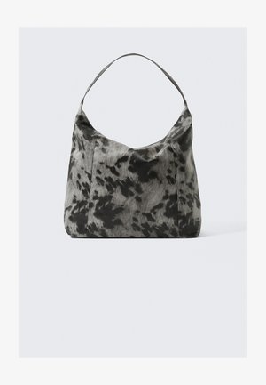 Black and gray spotted fabric bag with a curved silhouette, single handle, and soft texture, offering a casual and spacious design.