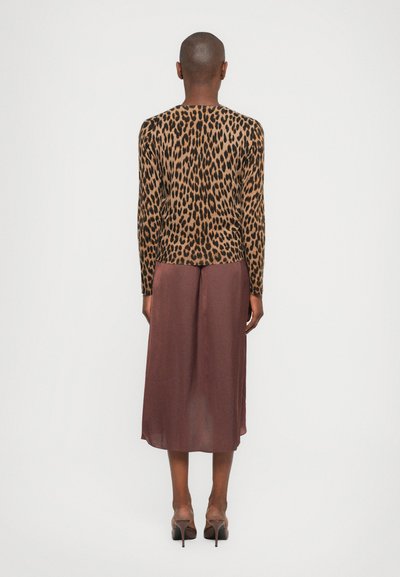 Leopard print long-sleeve top in brown and black, paired with a maroon mid-length skirt. Smooth texture and fitted design. Heels included.