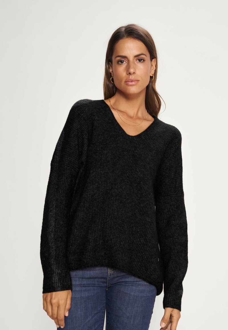 Zwarte gebreide trui met een V-hals, lange mouwen en een relaxed fit. Textuurstof met een iets oversized ontwerp.