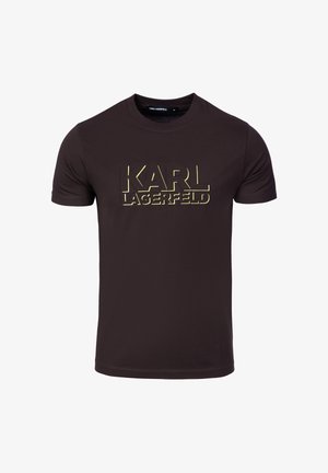 Hnědé tričko s krátkým rukávem z bavlny, na přední straně velký zlatý potisk s nápisem "KARL LAGERFELD", kulatý výstřih.