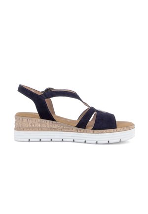 Navy blue suede wedge sandal with beige cork-textured midsole and white rubber outsole, featuring multiple straps and a slingback design.