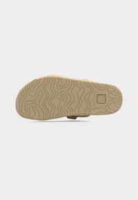 Σόλα παπουτσιού με υφασμένο σχέδιο, σε ανοιχτό καφέ χρώμα και από ομαλό καουτσούκ υλικό. Περιλαμβάνει αποτύπωμα με το λογότυπο της μάρκας.