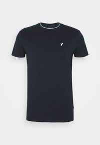 Marinblå bomullströja med rund halsringning och korta ärmar. Har en vit broderad logotyp på bröstet och kontrasterande kragdetaljer.