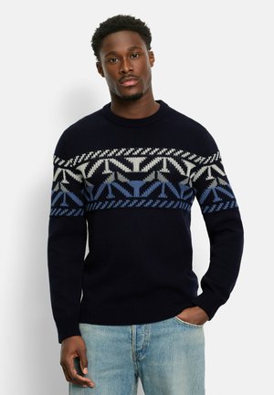 Navy blue knitted sweater featuring a geometric pattern in light gray and blue across the chest, round neckline, and ribbed cuffs.