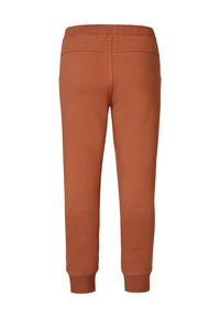 Oranje sweats met een zachte textuur, elastische tailleband en taps toelopende benen. Beschikt over twee achterzakken en ribgebreide manchetten.