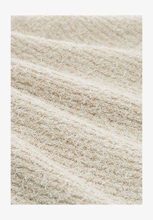 Kremowa tkanina o fakturze z małymi pętelkami i prążkami tworzącymi miękki, nierówny wzór powierzchni.