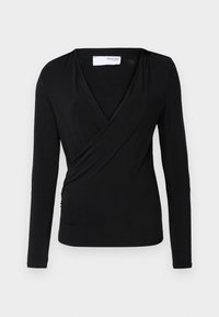 Top avvolgente a maniche lunghe di colore nero in morbido tessuto; presenta un profondo scollo a V e un dettaglio arricciato laterale per una forma aderente.