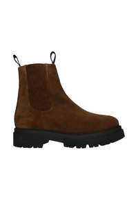 Botas Chelsea de ante marrón con una suela de goma negra gruesa, que cuentan con paneles laterales elásticos y tiradores para ponerlas y quitarlas con facilidad.