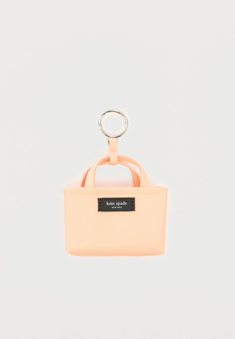 Μικρό μίνι τσαντάκι-μπρελόκ της Kate Spade σε ροδακινί χρώμα, με διπλές λαβές και ασημένιο κρίκο προσαρτημένο.