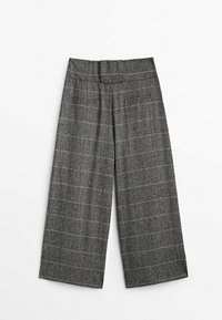 Pantalons large à carreaux gris avec un tissu texturé, dotés d'une taille haute et de coutures visibles. Rayures verticales et horizontales.