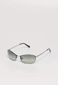 Metal sunglasses with a slim, elongated cat-eye shape, gray tinted lenses, and black rubber-accented temples.
