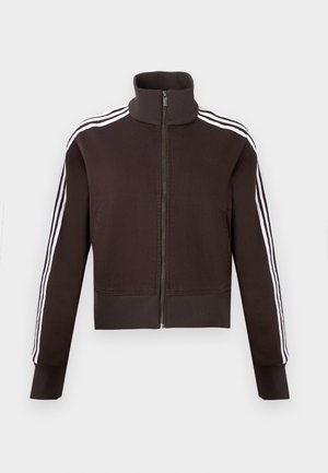 Brązowa kurtka na suwak z wysokim kołnierzem, z białymi paskami po bokach oraz ściągaczami przy mankietach i dole. Miękki materiał o dopasowanym kroju.