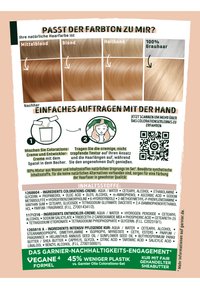 Produktförpackning för hårfärg: innehåller ljusbruna och blonda färgswatches, appliceringsanvisningar i krämform och ingredienslista på tyska, på en beige bakgrund.