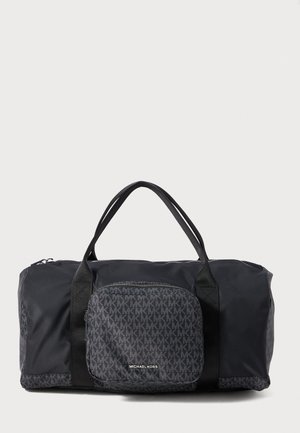 Sac de voyage Michael Kors noir avec double poignées, poche à fermeture éclair à l'avant présentant un motif de logo MK répétitif et la marque Michael Kors.