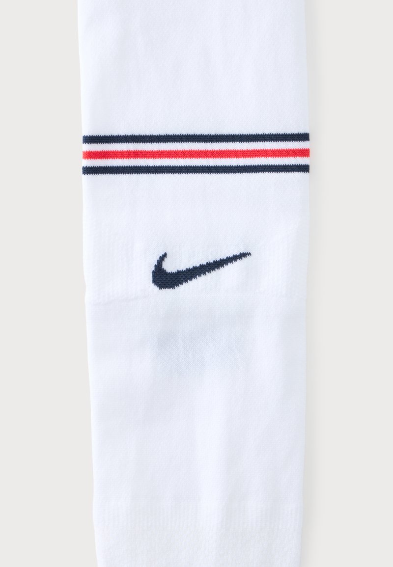 White sock with two navy and one red horizontal stripes near the top and a navy Nike swoosh logo below the stripes.