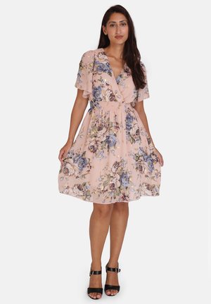 Floral print dress in soft pink fabric with short flutter sleeves, a cinched waist, and a flared skirt. Black strappy heels.