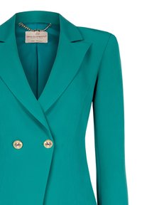 Blazer bleu sarcelle croisé avec boutons dorés, larges revers et petite chaîne à l'intérieur du col, coupe ajustée.