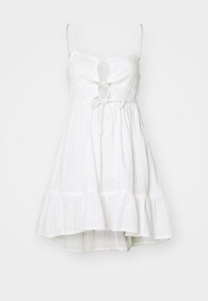 White sundress with adjustable spaghetti straps, keyhole cutout at the bust, elastic waist, and tiered flared skirt. Lightweight fabric.