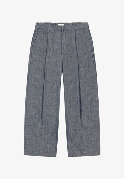 Gray wide-leg trousers with stitched pleats, side pockets, belt loops, and a white label at the elastic waistband.