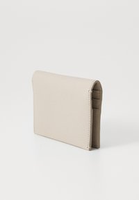 Beige leather wallet with a textured surface, rectangular shape, rounded edges, and a simple fold-over design. No visible hardware.