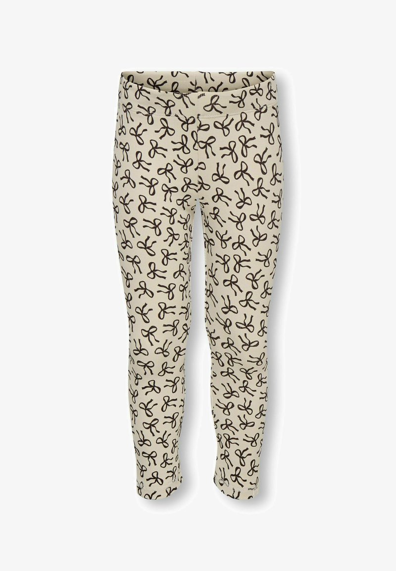 Leggings i creme med ribbet tekstur, prydet med et gentaget sort saks mønster. Elastisk talje, tætsiddende design, ankellang stil.