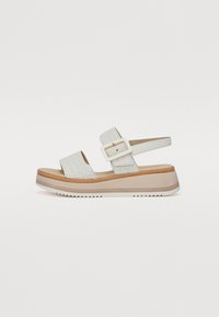 White wedge sandals with a textured upper, two adjustable straps, and a buckle detail. Thick platform sole with a contrasting brown accent.