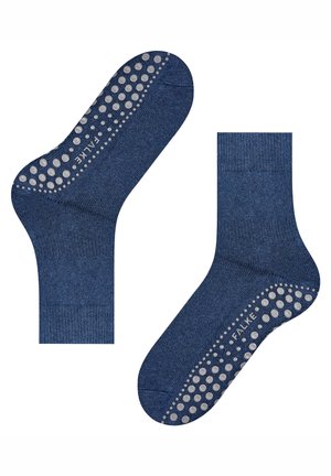 Deux chaussettes antidérapantes bleues avec des points de grip texturés blancs et un logo "FALKE" sur la zone des semelles, présentées côte à côte sur un fond blanc.