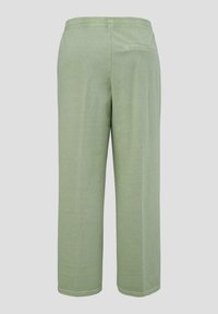Hellgrüne, locker sitzende Hose aus weichem Stoff, mit einem elastischen Bund und einer einzelnen Gesäßtasche. Schlichte Silhouette und Saum.
