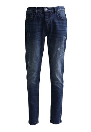 Tumma siniset slim-fit-farkut, joissa on hieman kulutettuja yksityiskohtia ja haalistumia reisissä ja polvissa, etutaskuilla ja napillissuljinnalla.