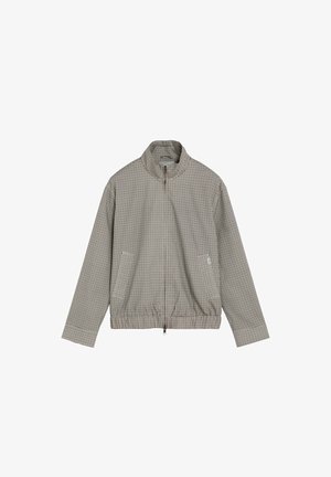 Veste zippée à manches longues avec petit motif à carreaux noir et blanc et taille élastique, affichée à plat sur fond blanc.