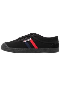 Black canvas sneakers with red and blue stripes, rubber toe cap, and textured black sole. Features a logo tag on the side.