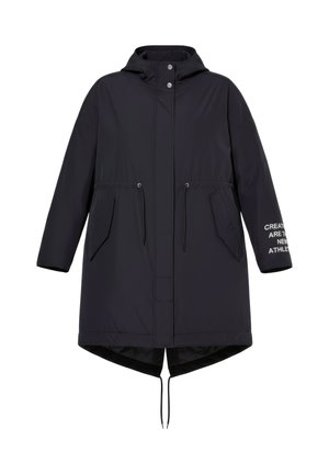 Lang sort hættejakke med trykknapper foran, snøre i taljen, klaplommer og tekst på højre ærmekant.