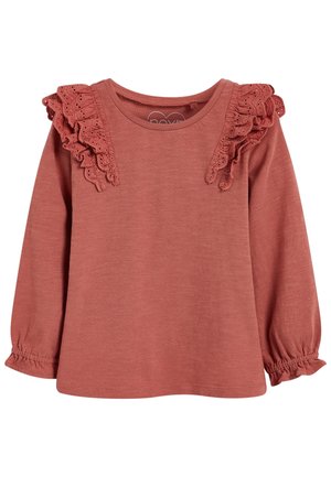 Haut à manches longues couleur vieux rose pour tout-petit avec volants en dentelle ajourée sur les épaules et poignets élastiqués.