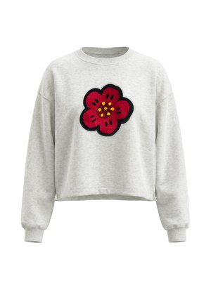 Lysegrå langærmet sweatshirt med et stort rødt blomsterpatch omkranset af sorte og gule detaljer centreret på brystet.