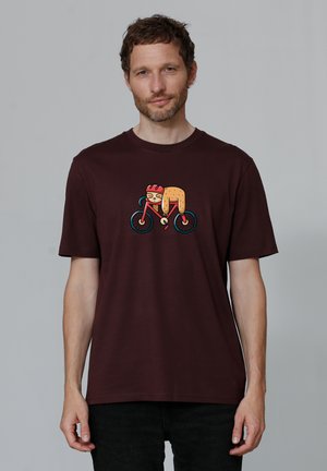 Maroon cotton t-shirt featuring a playful graphic of an animal on a bicycle. Short sleeves and crew neckline. Smooth texture.