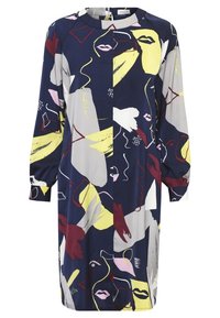 Meriino muoti, jossa on abstrakteja kukka- ja viivakuviota keltaisessa, punaisessa, harmaassa ja vaaleanpunaisessa. Pitkät hihat, joissa on kokoontuneita hihansuita, rento istuvuus.