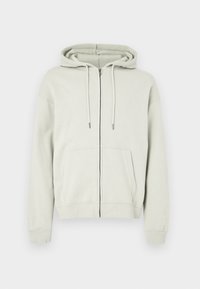 Šviesiai pilkas užtrauktuku užsegamas džemperis iš minkšto medvilnės audinio, turintis erdvias priekinę kišenę, reguliuojamą gobtuvą su raišteliu bei ribotas rankogalius ir apačią.