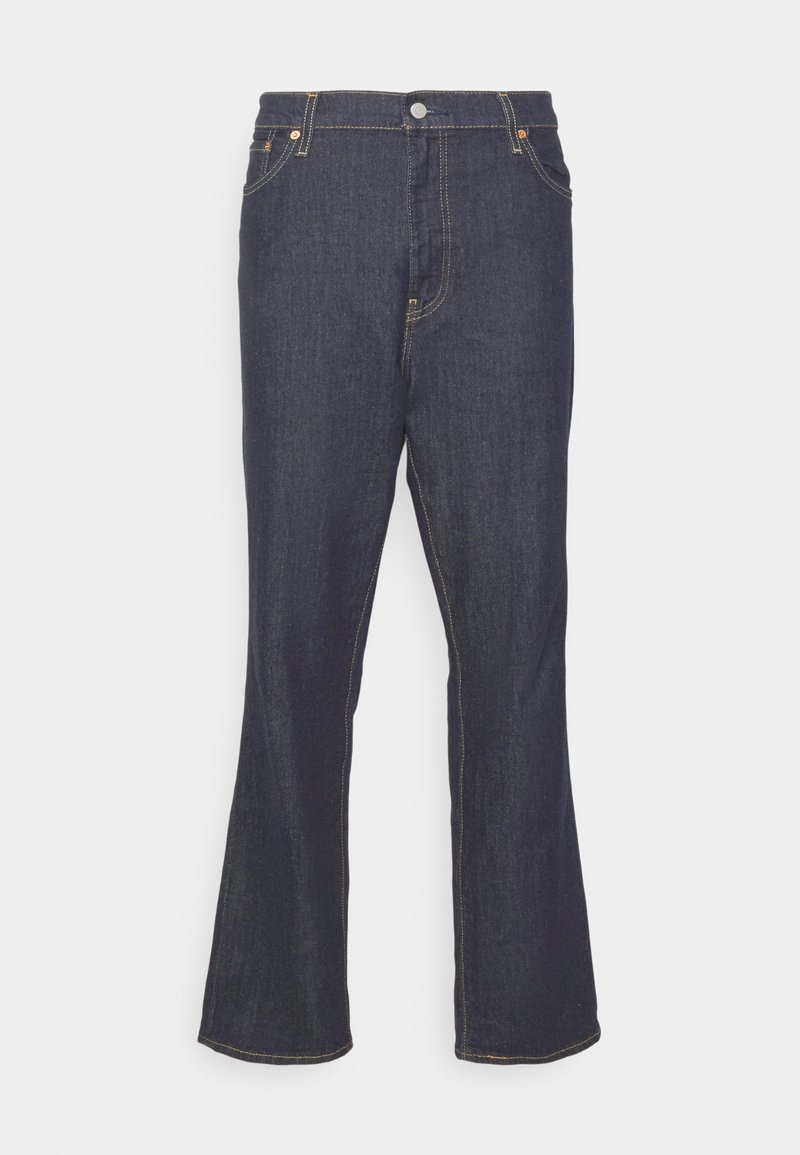 Jean en denim bleu foncé évasés avec une taille haute, bords finis et coutures contrastantes orange. Dispose de poches avant et d'une fermeture à bouton.