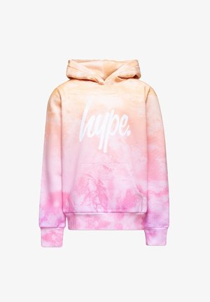 Sweat-shirt à capuche en dégradé de tons pêche et rose, arborant un grand logo blanc "hype." et une poche frontale. Texture de tissu douce.