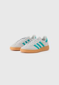 Grå ruskinds sneakers med turkise striber, gummisole og teksturerede detaljer. Har et snørebåndsdesign og polstret krave.