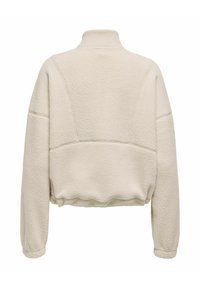 Cream-colored fleece pullover with a high collar, dropped shoulders, and elasticized hem. Textured, soft material with a relaxed fit.