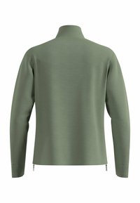 Grünes Langarmoberteil mit hohem Kragen, strukturiertem Stoff und seitlichen Reißverschlüssen am Saum für zusätzliche Details. Glattes, figurbetontes Design.