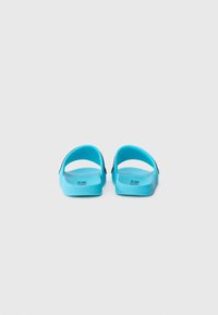 Blue rubber sandals with an open back, wide straps, and textured footbed. Features a black accent near the heel. Lightweight design.
