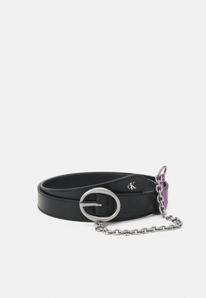 Black leather belt with oval silver buckle, small "cK" logo, and silver chain detail attached to a purple fabric loop.