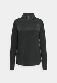 Pull en polaire noir avec un col haut et une fermeture éclair sur le devant. Présente une section inférieure texturée et le logo CK sur la poitrine.