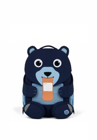 Marineblaue und hellblaue, bärenförmige Rucksack mit großen Augen, einer Zunge und Namensschild. Verfügt über gepolsterte Griffe und Seitentaschen zur Aufbewahrung.