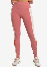 High-waisted leggings in soft pink with white and orange side panels. Features a smooth, stretchy fabric and a fitted design.